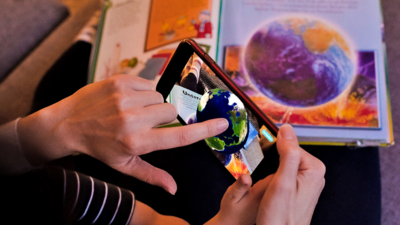 Interactive AR Book with smartphone showing a globe